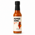 A bottle of Pepper Song Anytime Red hot sauce on a clean white background. The clear glass bottle shows the orange-red sauce inside, topped with a black cap and featuring a cream-colored label with black and red text and chili pepper illustrations.