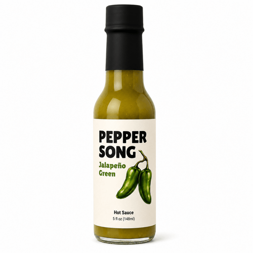 A 5 fl oz bottle of Pepper Song Jalapeño Green hot sauce, featuring a cream-colored label with black and green text and an illustration of two green jalapeños, topped with a black cap on a white background.