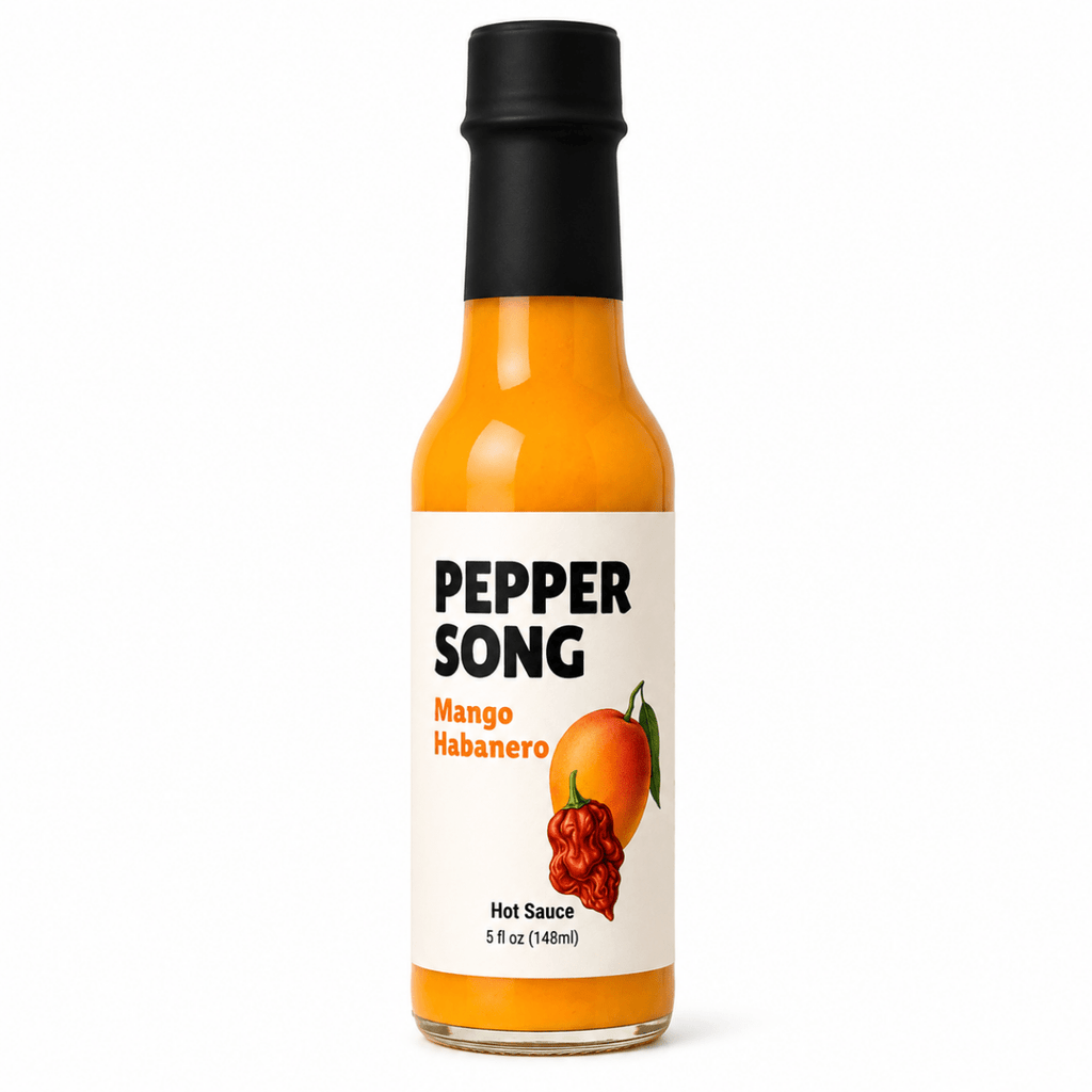 A bottle of Pepper Song Mango Habanero hot sauce on a clean white background. The glass bottle shows the bright orange sauce inside, topped with a black cap and featuring a white label with black and orange text and a chili pepper illustration.