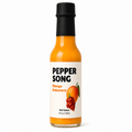 A bottle of Pepper Song Mango Habanero hot sauce on a clean white background. The glass bottle shows the bright orange sauce inside, topped with a black cap and featuring a white label with black and orange text and a chili pepper illustration.